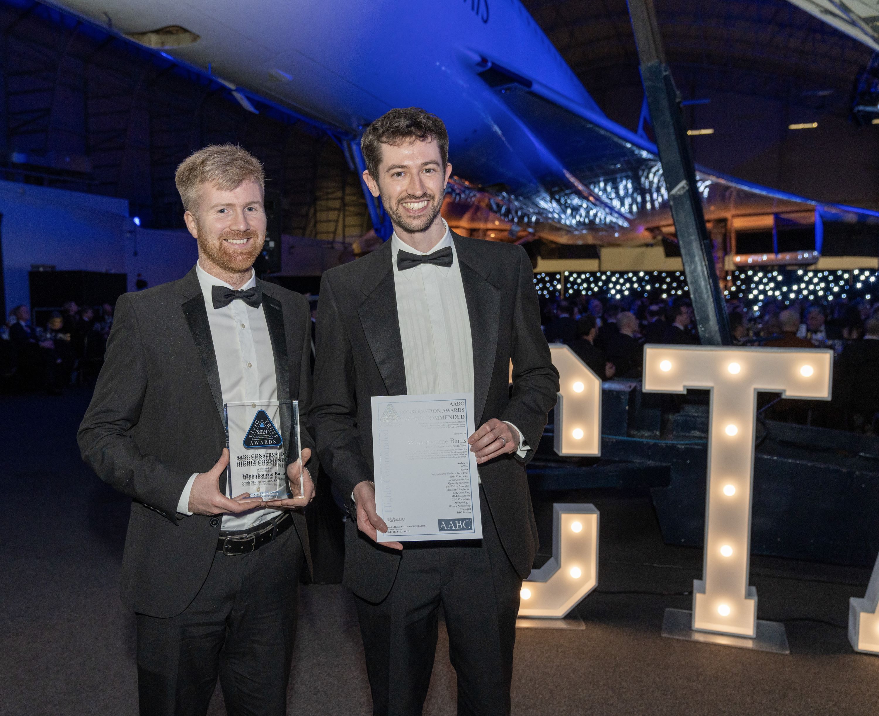 Mark Slater and Matt Hinkins at the Civic Trust Award prize giving standing under the Concorde